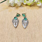silver earrings with green gemstones